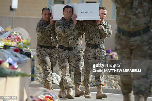 Maltese soldiers carry a coffin of a baby during the funeral ceremony of 24 migrants who died after a fishing boat carrying migrants capsized off the...
