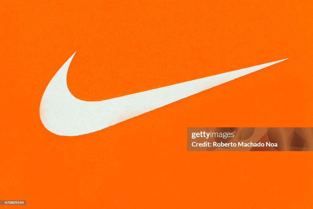 White Nike Logo on Orange Background;Nike, Inc. is an American... News  Photo - Getty Images