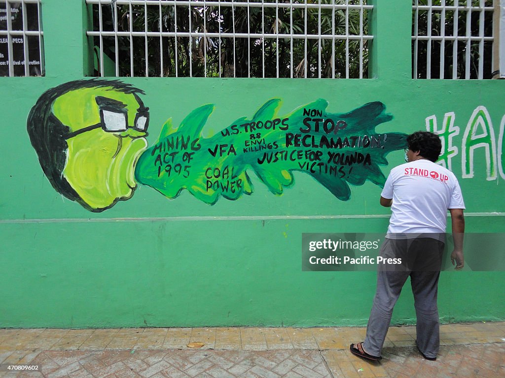 A Filipino environmental activist paints Philippine...