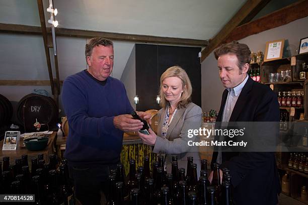 Conservative parliamentary candidate Marcus Fysh looks at cider produced at Perry's Cider mill with John Perry as he is joined by Conservative MP and...