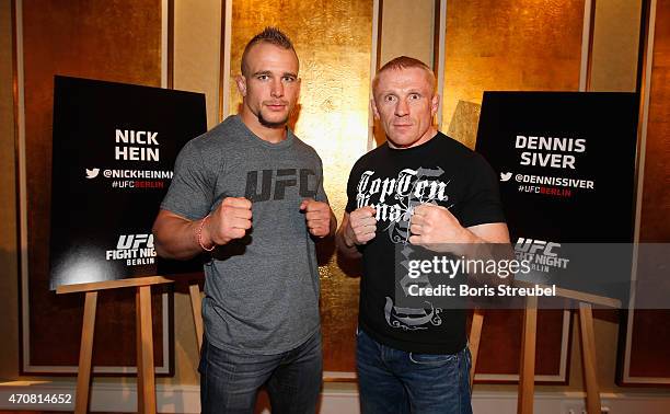 Nick Hein of Germany and Dennis Siver of Russia pose during the UFC press conference at O2 World on April 23, 2015 in Berlin, Germany.