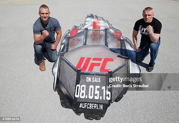 Nick Hein of Germany and Dennis Siver of Russia pose in front of a Grafitti artwork after the UFC press conference at O2 World on April 23, 2015 in...