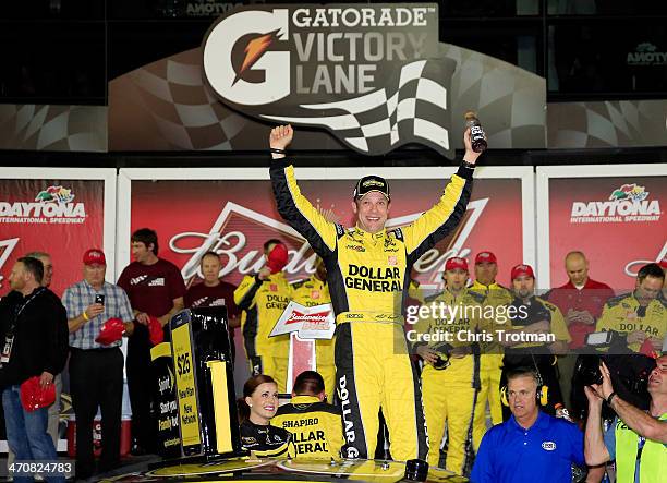 Matt Kenseth, driver of the Dollar General Toyota, celebrates in Victory Lane after winning the NASCAR Sprint Cup Series Budweiser Duel 1 at Daytona...