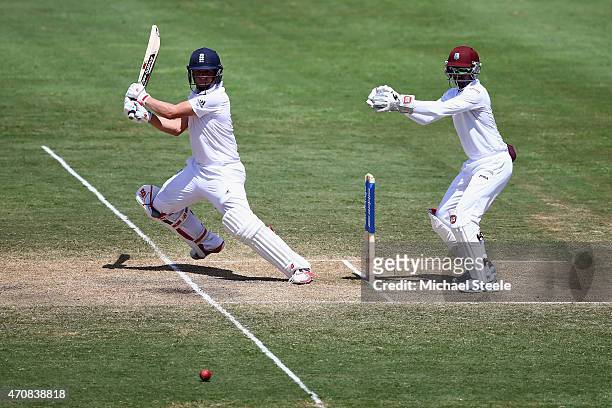 Gary Ballance of England cuts as wicketkeeper Densh Ramdin of West Indieslooks on during day three of the 2nd Test match between West Indies and...