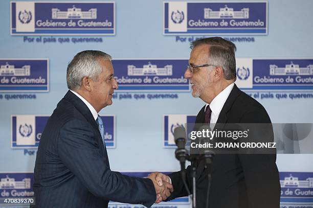 Guatemalan President Otto Perez Molina shakes hands with Colombian Ivan Velasquez, chief of the International Commission against Impunity in...