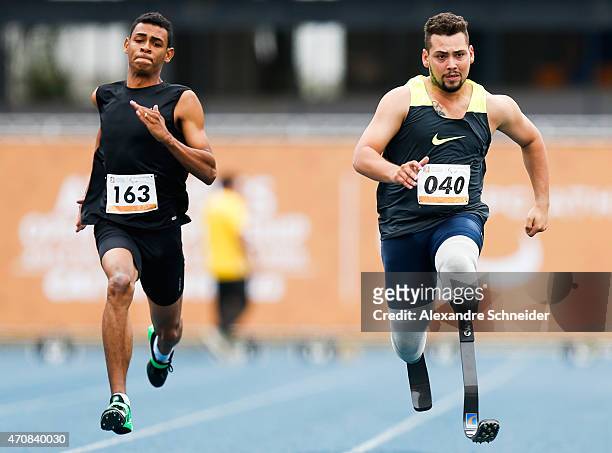 Kesley Teodoro of Brazil and Alan Oliveira of Brazil compete in the Men's 100 meters qualifying at Ibirapuera Sports Complex during day one of the...