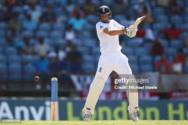 Joe Root of England hits to the offside during day three of the 2nd Test match between West Indies and England at the National Cricket Stadium in St...