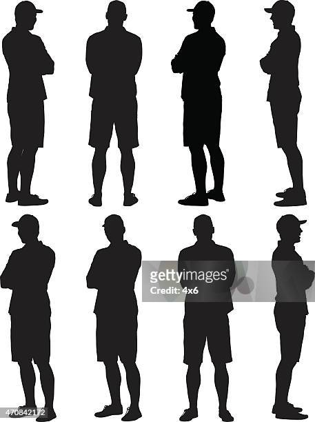 casual man standing arms crossed - shorts stock illustrations