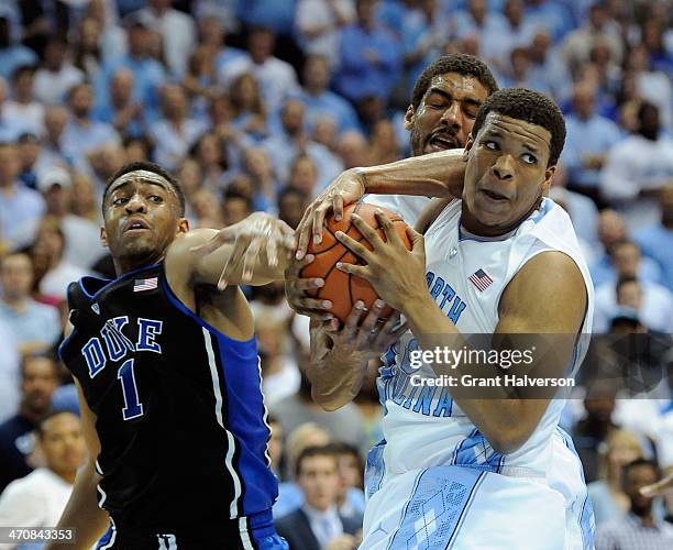 Jabari Parker of the Duke Blue Devils battles James Michael McAdoo and Kennedy Meeks of the North Carolina Tar Heels for a rebound during their game...