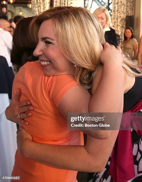 Boston Marathon bombing survivor Heather Abbott embraces fellow survivor Jane Richard. Abbott hosted the launch party for the Heather Abbott...