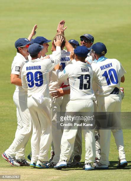 Doug Bollinger of the Blues is congratulated by team mates after dismissing Cameron Bancroft of the Warriors in the first ball of the innings during...