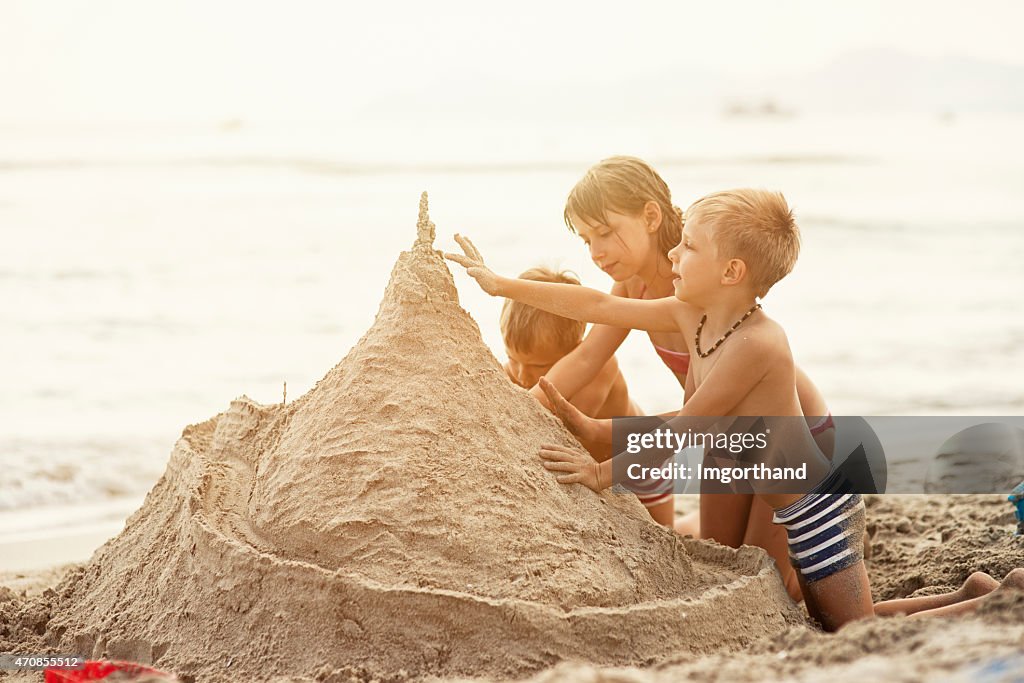 Bambini costruire castelli di sabbia di un gigante