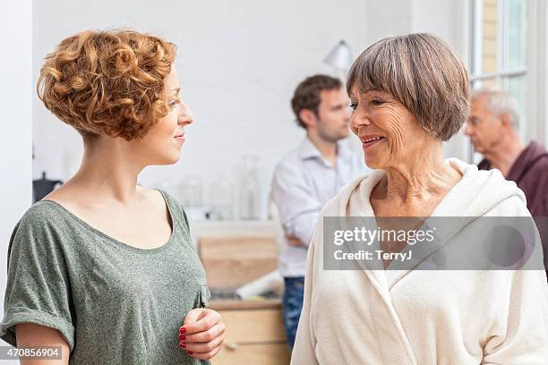 daughter in law seeks advice from mother in law - father in law stock pictures, royalty-free photos & images