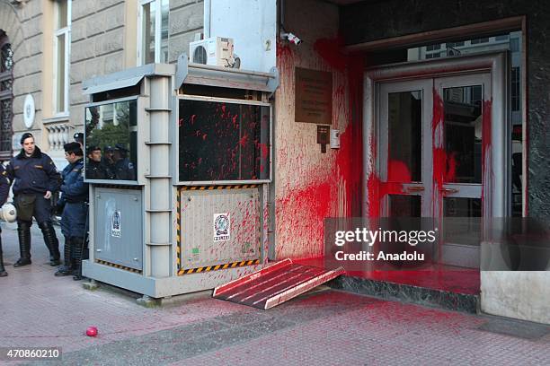 Policemen stand at the entrance of the European Commission offices in Athens, Greece on April 23 covered in red paint thrown by protesters during a...