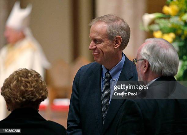 Illinois Gov. Bruce Rauner, center, arrives for the funeral Mass for Cardinal Francis George at Holy Name Cathedral on April 23, 2015 in Chicago,...