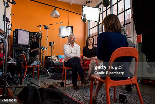 Richard Branson, chairman and founder of Virgin Group Ltd., left, and Sheryl Sandberg, chief operating officer of Facebook Inc., listen during a...