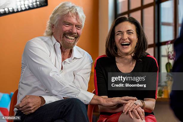 Richard Branson, chairman and founder of Virgin Group Ltd., left, and Sheryl Sandberg, chief operating officer of Facebook Inc., have a laugh during...