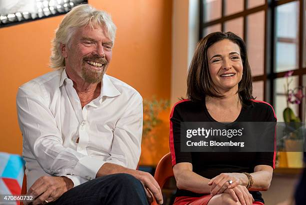 Richard Branson, chairman and founder of Virgin Group Ltd., left, listens as Sheryl Sandberg, chief operating officer of Facebook Inc., speaks during...