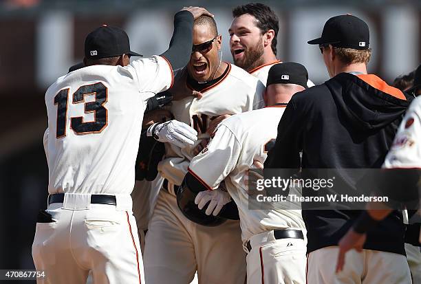 Justin Maxwell of the San Francisco Giants celebrates with Joaquin Arias and other teammates after Maxwell hit a walk-off rbi single scoring Angel...