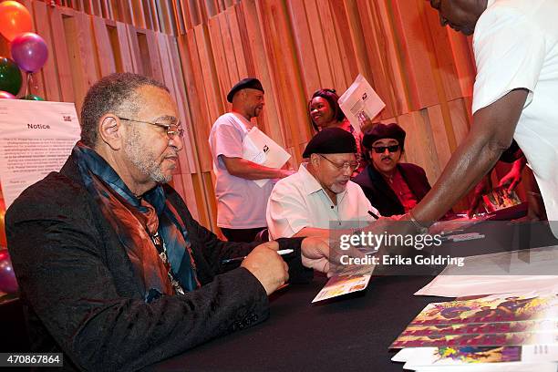 George Porter Jr, Art Neville and Leo Nocentelli of the original The Meters sign envelopes during the Jazz Fest Postal Cachet unveiling at George and...