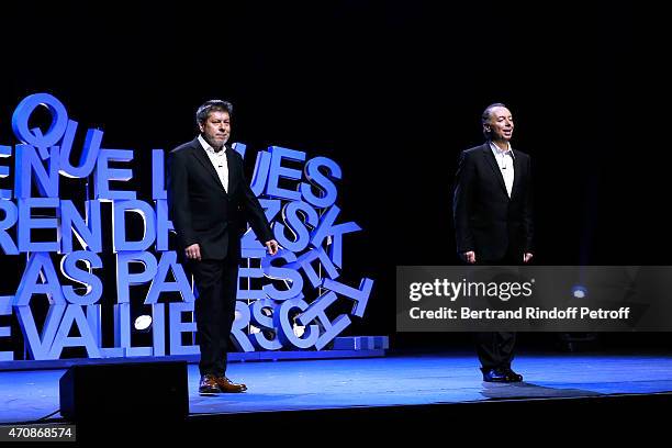 French Humorists Regis Laspales and Philippe Chevallier acknowledge the applause of the audience at the end of their show "Vous reprendrez bien...