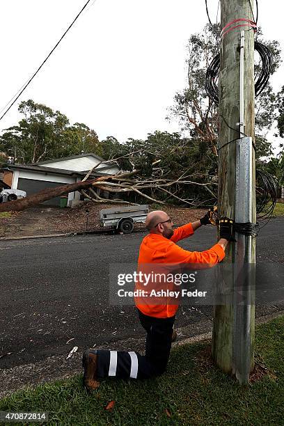 Workers continue the clean up effort in North Avoca on April 24, 2015 in Gosford, Australia. Gosford City and Wyong shire have official been declared...