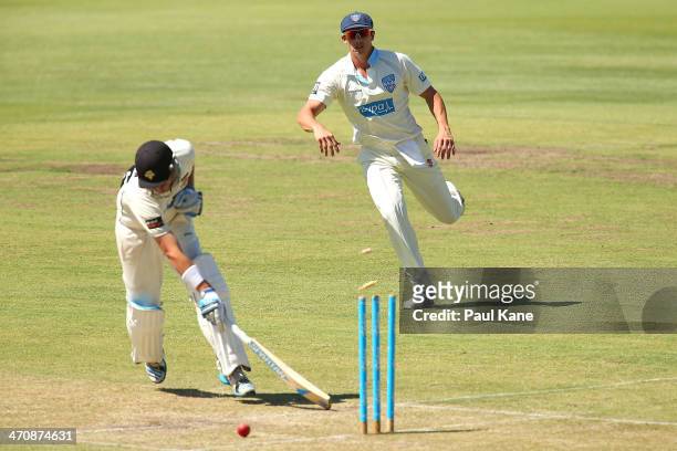 Sean Abbott of the Blues hits the stumps to run out of Marcus North of the Warriors during day two of the Sheffield Shield match between the Western...