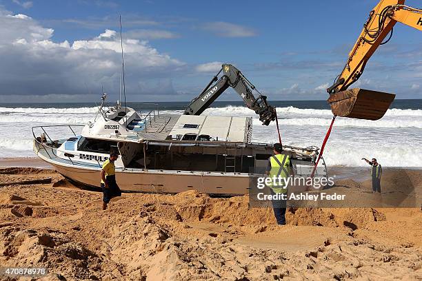 Clean up operations begin on the boat "Impulse" at Wamberal Beach on April 23, 2015 in Gosford, Australia. Gosford City and Wyong shire have official...