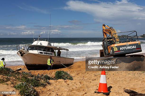 Clean up operations begin on the boat "Impulse" at Wamberal Beach on April 23, 2015 in Gosford, Australia. Gosford City and Wyong shire have official...