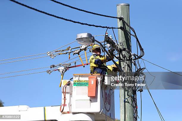 Workers repair power lines at Kincumber on the Central Coast on April 24, 2015 in Gosford, Australia. Gosford City and Wyong shire have official been...