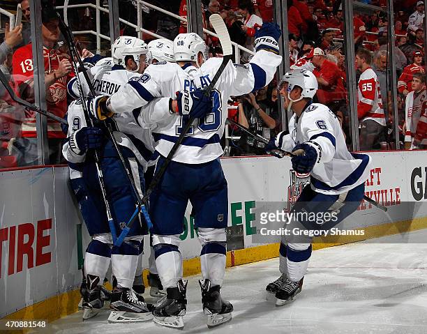 Anton Stralman of the Tampa Bay Lightning celebrates with teammates after a game winning overtime goal by Tyler Johnson to beat the Detroit Red Wings...