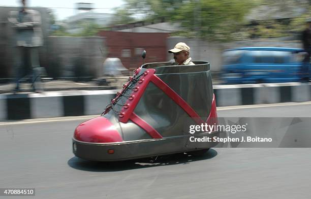 Mr. K. Sudhakar rides a shoe car outside the Sudha Cars Museum. He is a Guinness World Record holder for making the Largest Tricycle in the World.