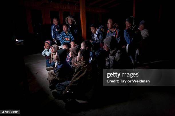 Students in the Great Compassion Boarding School watch a Bollywood movie on a television set. Hidden in the rain shadow of the Himalaya in one of the...