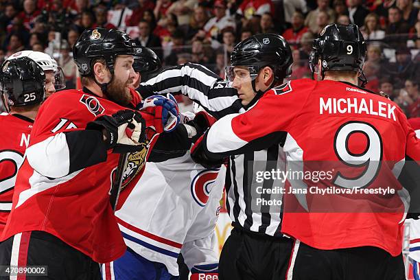 Linesman Bryan Pancich tries to separate Zack Smith and Milan Michalek of the Ottawa Senators from members of the Montreal Canadiens in Game Four of...