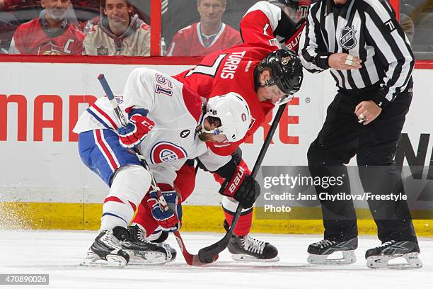 Kyle Turris of the Ottawa Senators fights for possession of the puck against David Desharnais of the Montreal Canadiens following a face-off in Game...