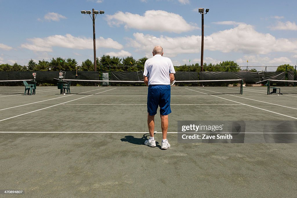 Rear view of senior man on tennis court