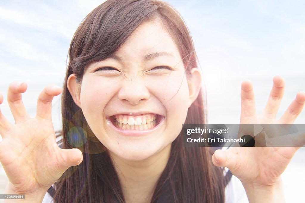 Young woman pulling funny face and hands like claws