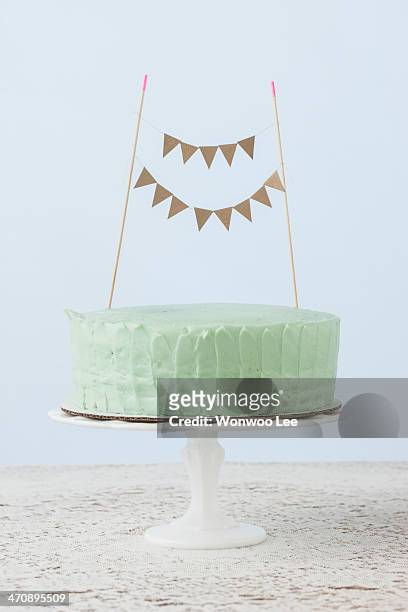 still life of celebration cake decorated with flag bunting - birthday flag stock-fotos und bilder