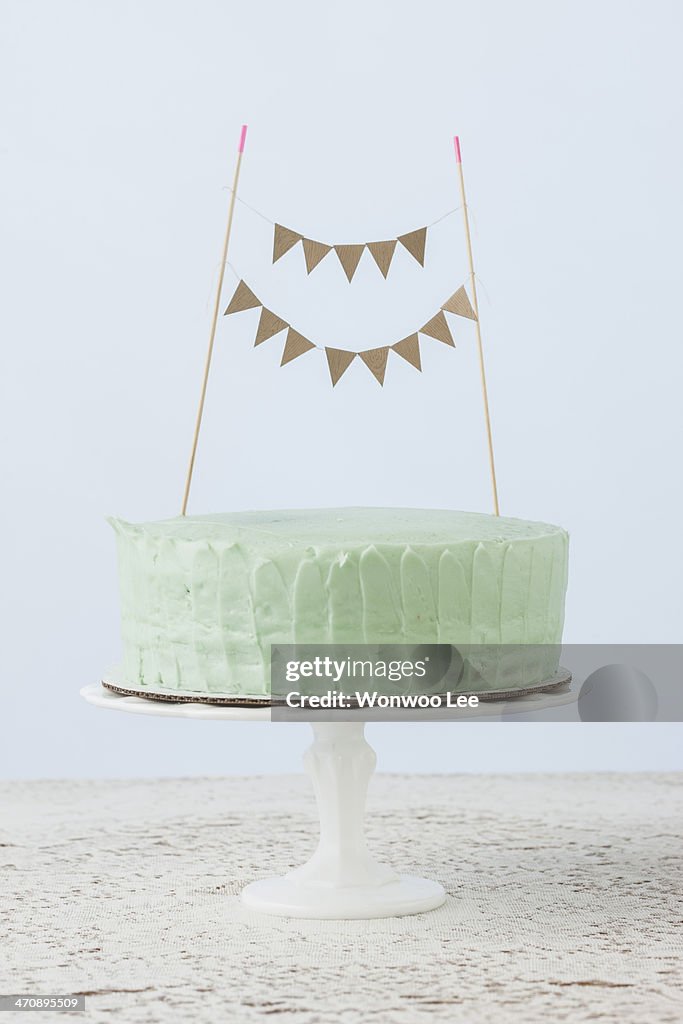 Still life of celebration cake decorated with flag bunting