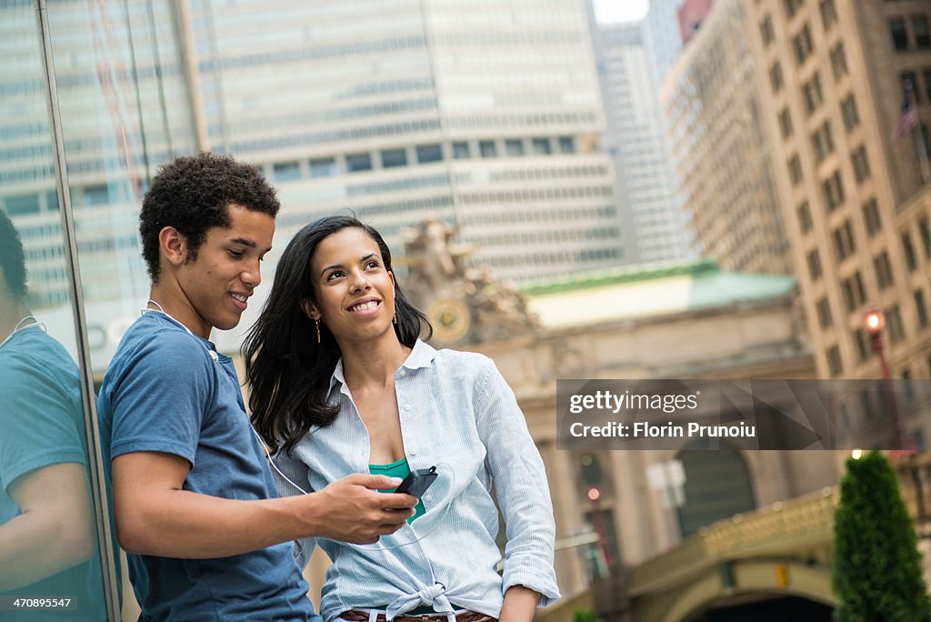 Couple reading text message on mobile phone