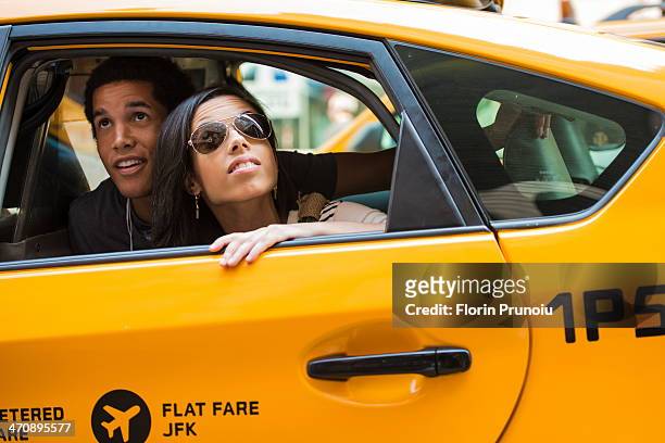 couple looking up from cab window - nyc cab stock-fotos und bilder
