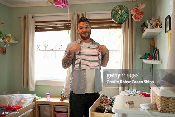 father putting away child's laundry - laundry persons stock pictures, royalty-free photos & images