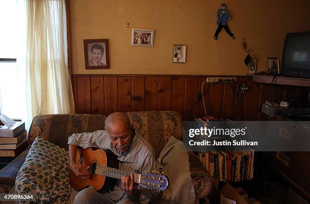 Porterville resident Manuel Dominguez, who has no running water, plays guitar in his living room on April 23, 2015 in Porterville, California. Over...