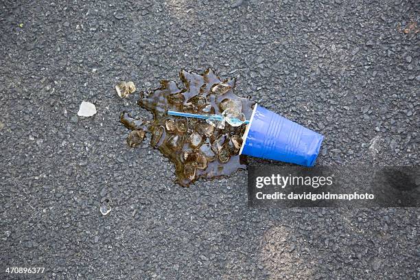 spilled soft drink with plastic cup and ice cubes on tarmac - chatham new york state stock pictures, royalty-free photos & images