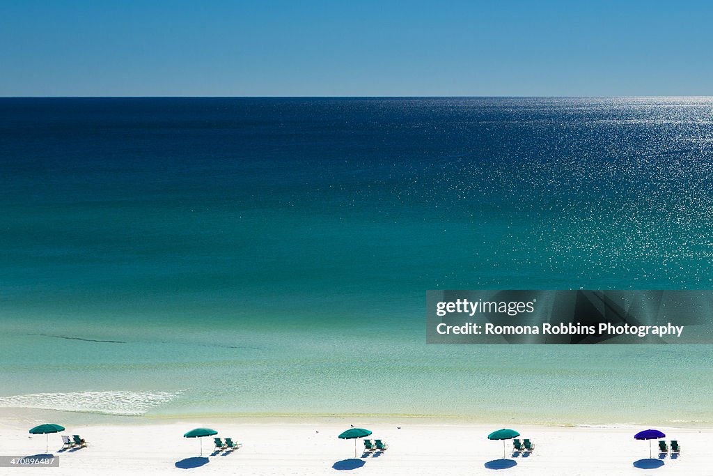 Beach umbrellas and deck chairs on beach, Destin, Florida, USA
