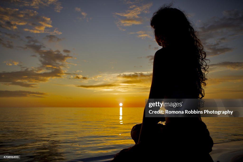 Woman watching sunset, Port St Joe, Florida, USA