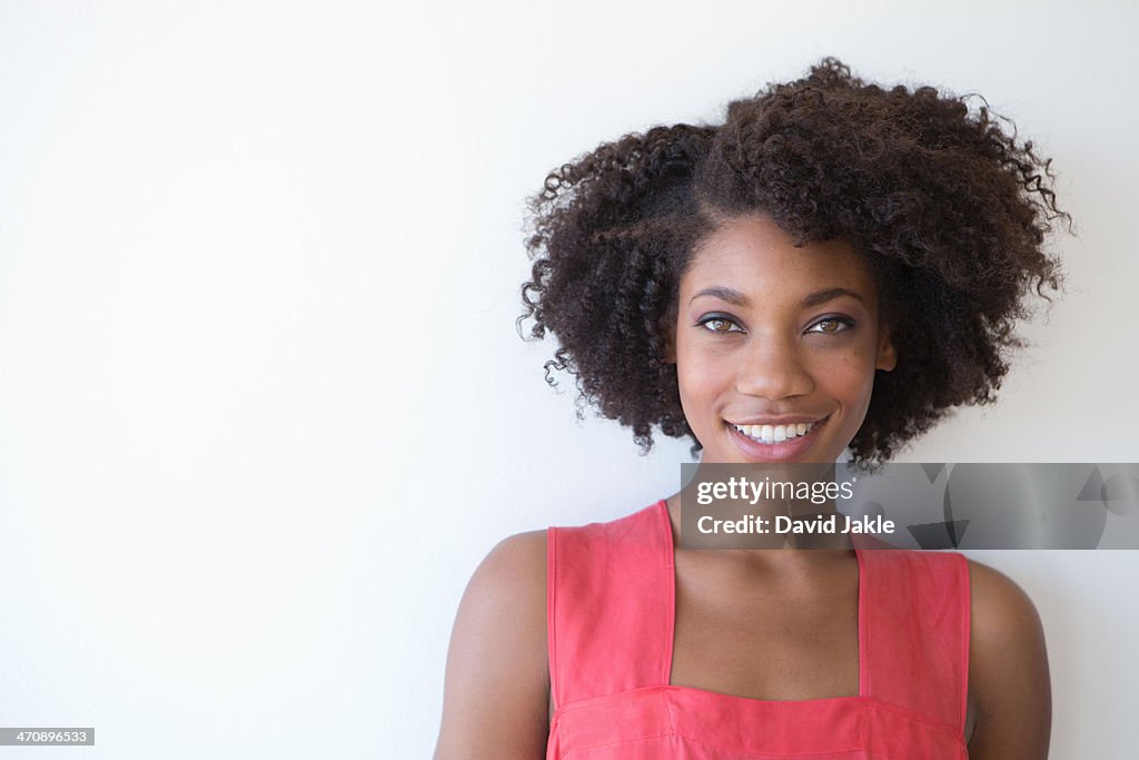 Portrait of young woman against white background