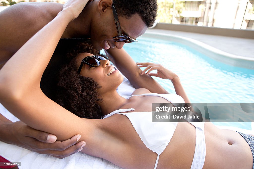 Portrait of young couple at poolside