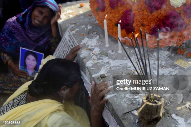 Bangladeshi mourners and relatives of a victim of the Rana Plaza building collapse weep as they mark the second anniversary of the disaster at the...