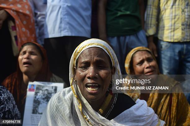 Bangladeshi mourners and relatives of a victim of the Rana Plaza building collapse, weep as they mark the second anniversary of the disaster at the...